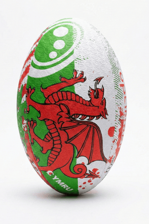 White, green and red Optimum Wales rugby ball with red Welsh dragon and CYMRU print, upright on white - Optimum