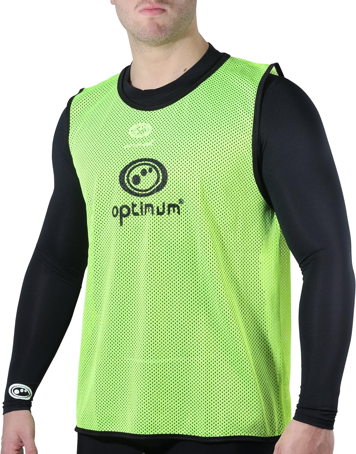 Fluorescent yellow mesh Optimum training bib with black logo worn by a man over black top, front view - Optimum